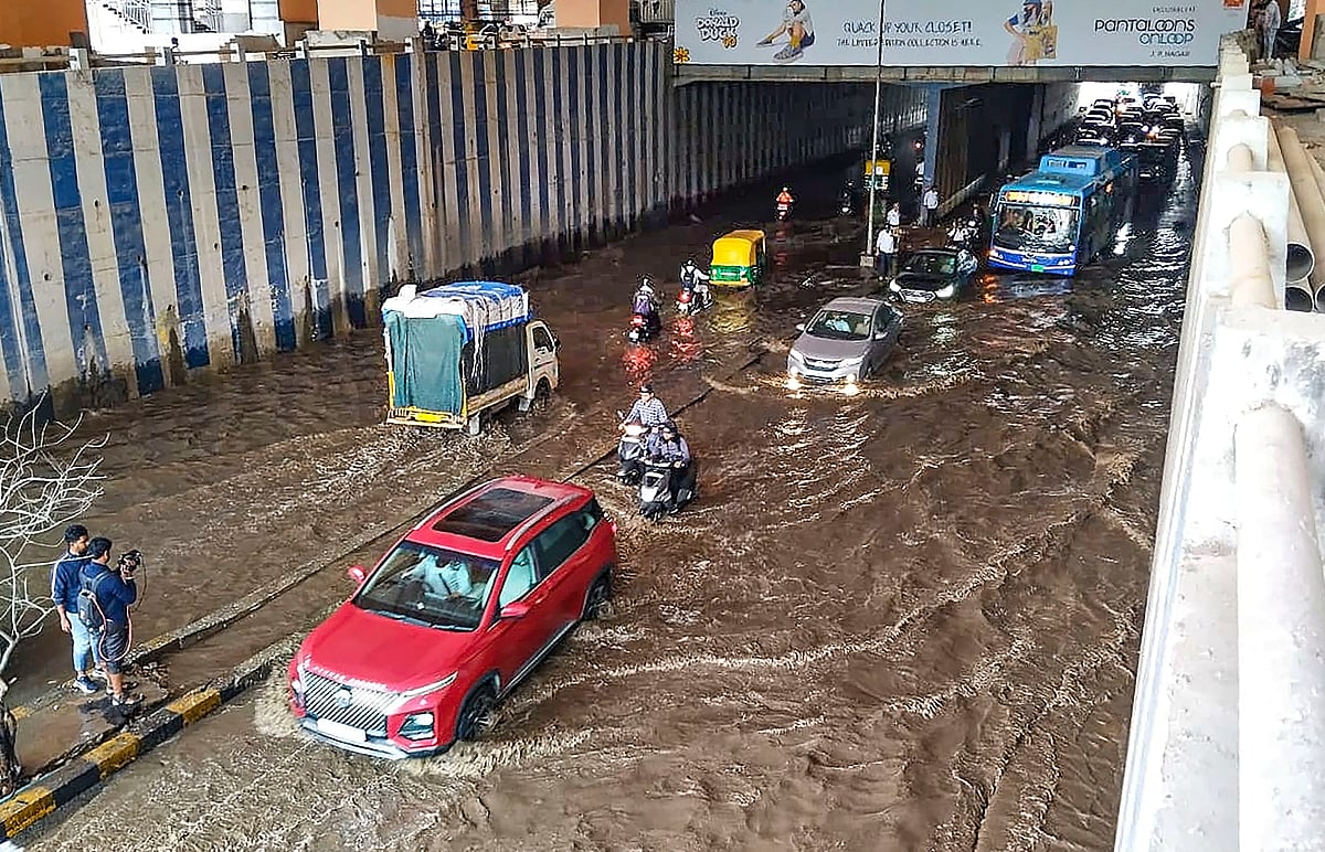 PTI : Vehicles pass through a waterlogged underpass near Jayadeva Hospital after heavy rainfall, in Bengaluru, Monday, Aug 12 
